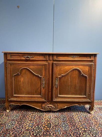 Moulded natural wood sideboard opening to...