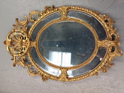 Oval wood and gilded stucco mirror with shell...