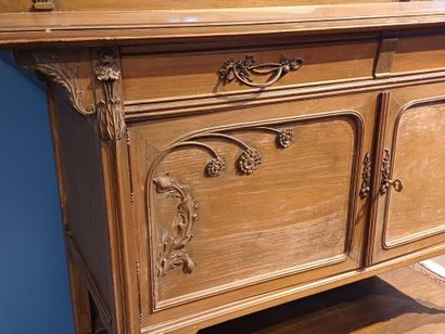 Wooden sideboard carved with flowers, the...