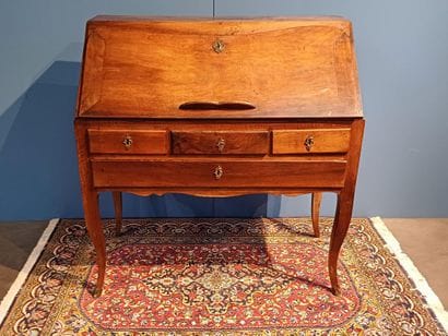 Walnut sloping desk opening to a flap revealing...