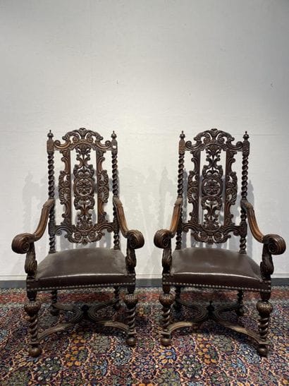 Pair of walnut armchairs, richly carved with...