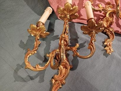 Pair of three-light sconces in chased and...