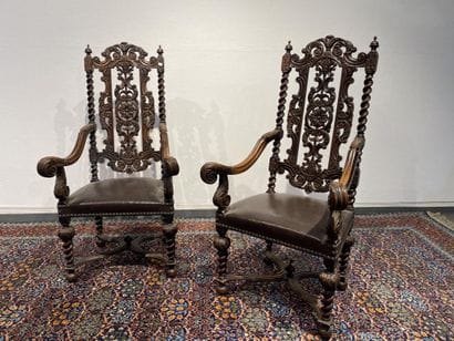 Pair of walnut armchairs, richly carved with...