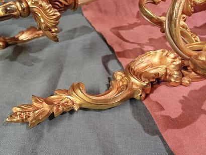 Pair of three-light sconces in chased and...