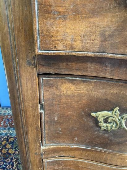 Curved-front chest of drawers in molded walnut...