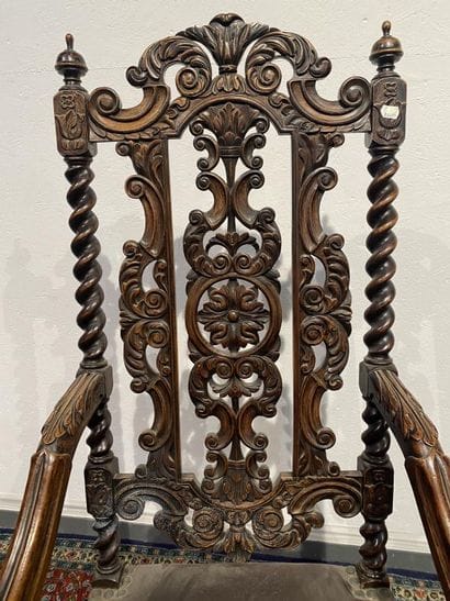 Pair of walnut armchairs, richly carved with...