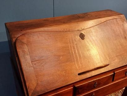 Walnut sloping desk opening to a flap revealing...