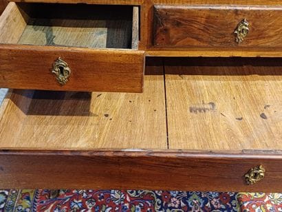 Walnut sloping desk opening to a flap revealing...