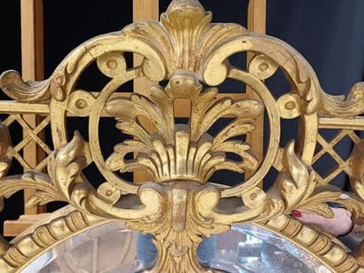 Oval wood and gilded stucco mirror with shell...