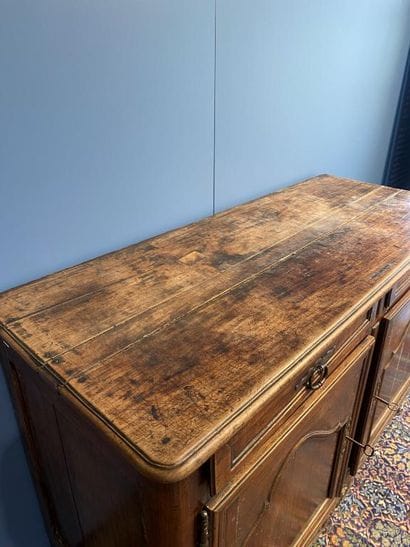 Moulded natural wood sideboard opening to...