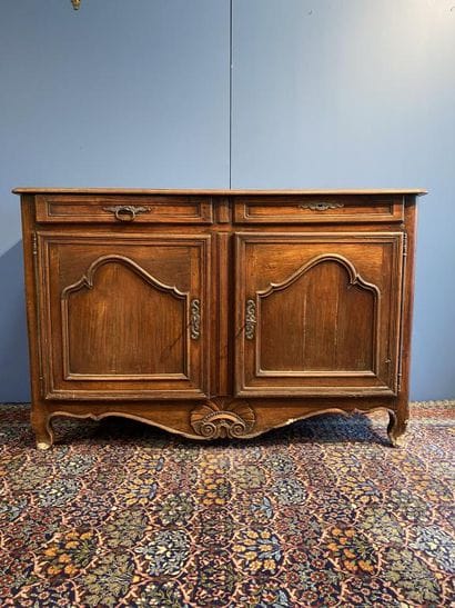 Moulded natural wood sideboard opening to...