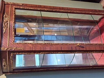 A three-sided-glazed, curved display case...