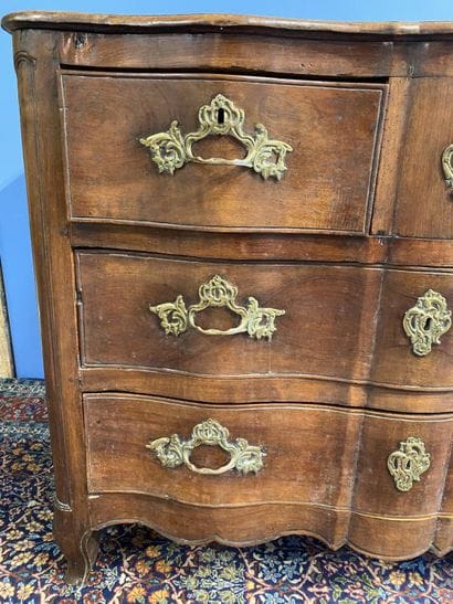 Curved-front chest of drawers in molded walnut...