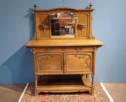 Wooden sideboard carved with flowers, the...