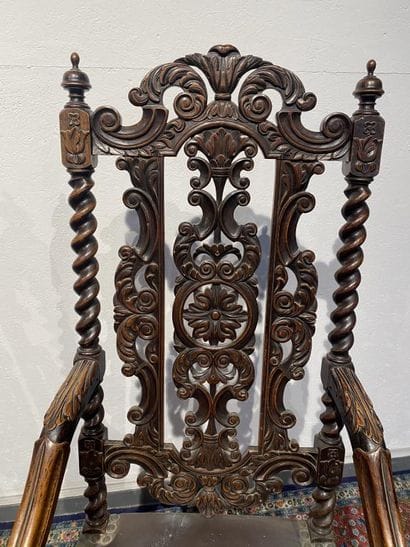 Pair of walnut armchairs, richly carved with...