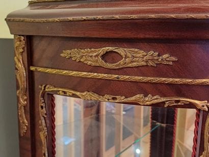 A three-sided-glazed, curved display case...