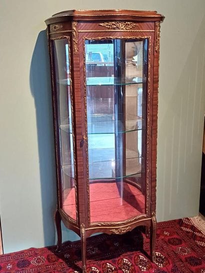 A three-sided-glazed, curved display case...