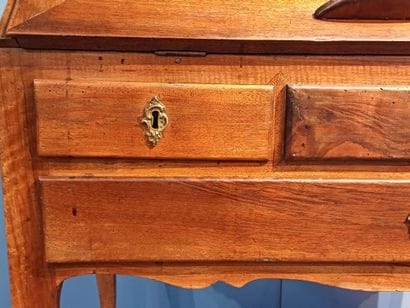 Walnut sloping desk opening to a flap revealing...