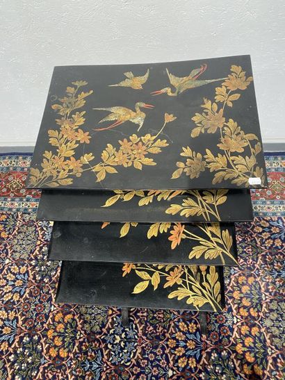 Set of four nesting tables in black lacquered...