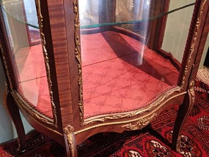 A three-sided-glazed, curved display case...