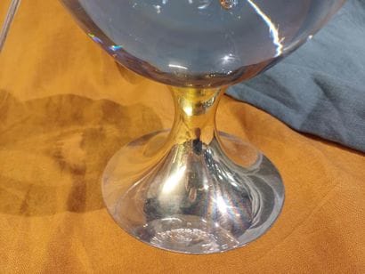 Brass lamp base adorned with a bubble glass...