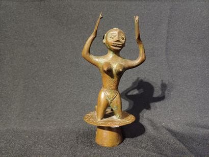 Kneeling figure on a pedestal, raising his...
