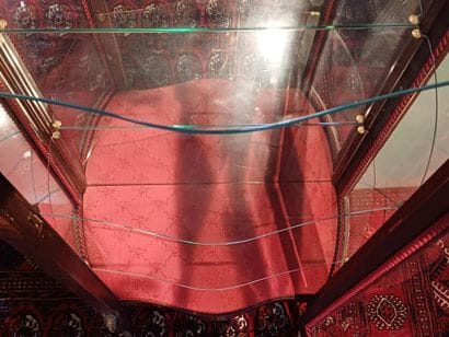 A three-sided-glazed, curved display case...