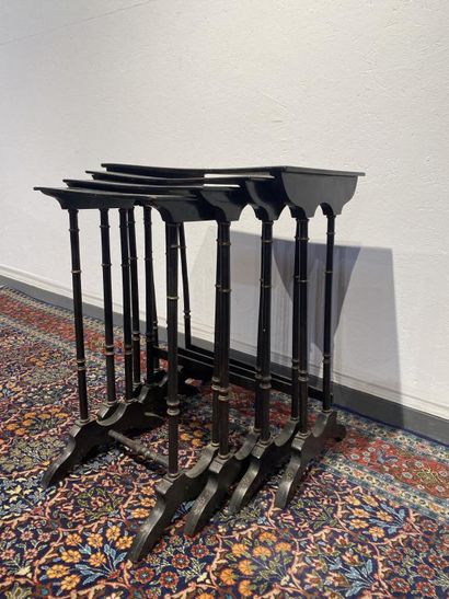 Set of four nesting tables in black lacquered...