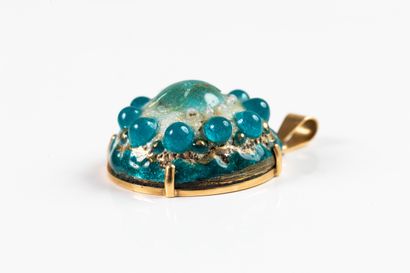 Yellow gold pendant adorned with a blue and...