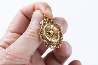 Medallion pendant topped with a pearl in...