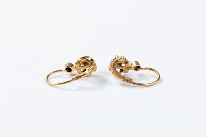 Pair of gold sleeper earrings centered on...