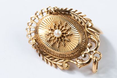 Medallion pendant topped with a pearl in...