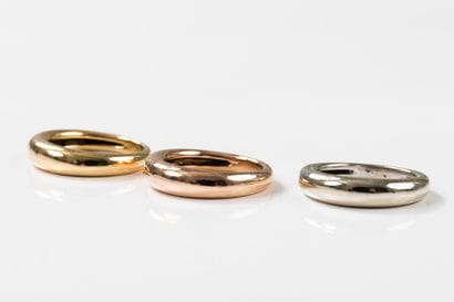 Three rings, one in yellow, one in pink and...
