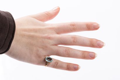 Yellow gold ring centered on an aquamarine...