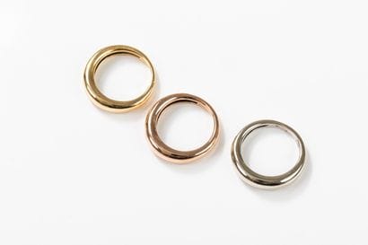 Three rings, one in yellow, one in pink and...