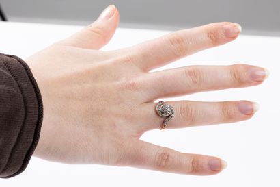 Yellow and white gold ring centered on an...