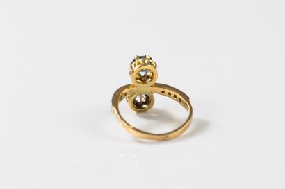 toi et moi gold ring set with a round sapphire...