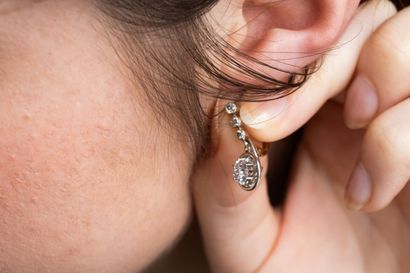 Pair of earrings adorned with three diamonds...