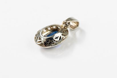 Gold pendant set at its center with a synthetic...