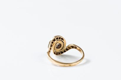 Yellow and white gold ring centered on an...