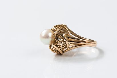 Yellow gold ring centered with a cultured...