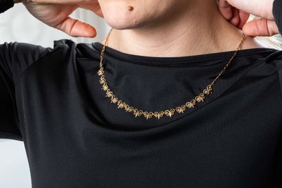 Yellow gold choker necklace centered with...