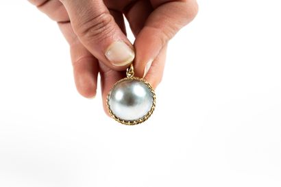 Yellow gold pendant adorned with a large...
