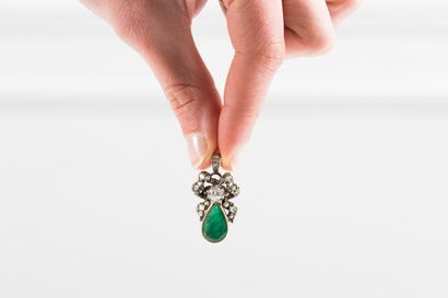 Gold and silver pendant adorned with a drop...