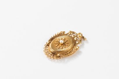 Medallion pendant topped with a pearl in...