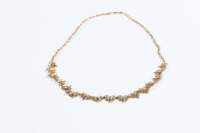 Yellow gold choker necklace centered with...