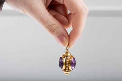 Gold pendant featuring a lantern set with...