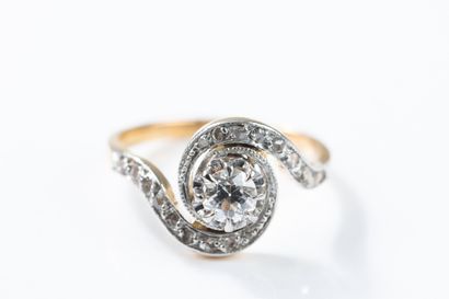 Yellow and white gold ring centered on an...