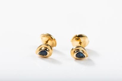 Pair of pear-shaped gold earrings centered...