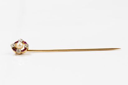 Gold tie pin featuring a circular motif centered...